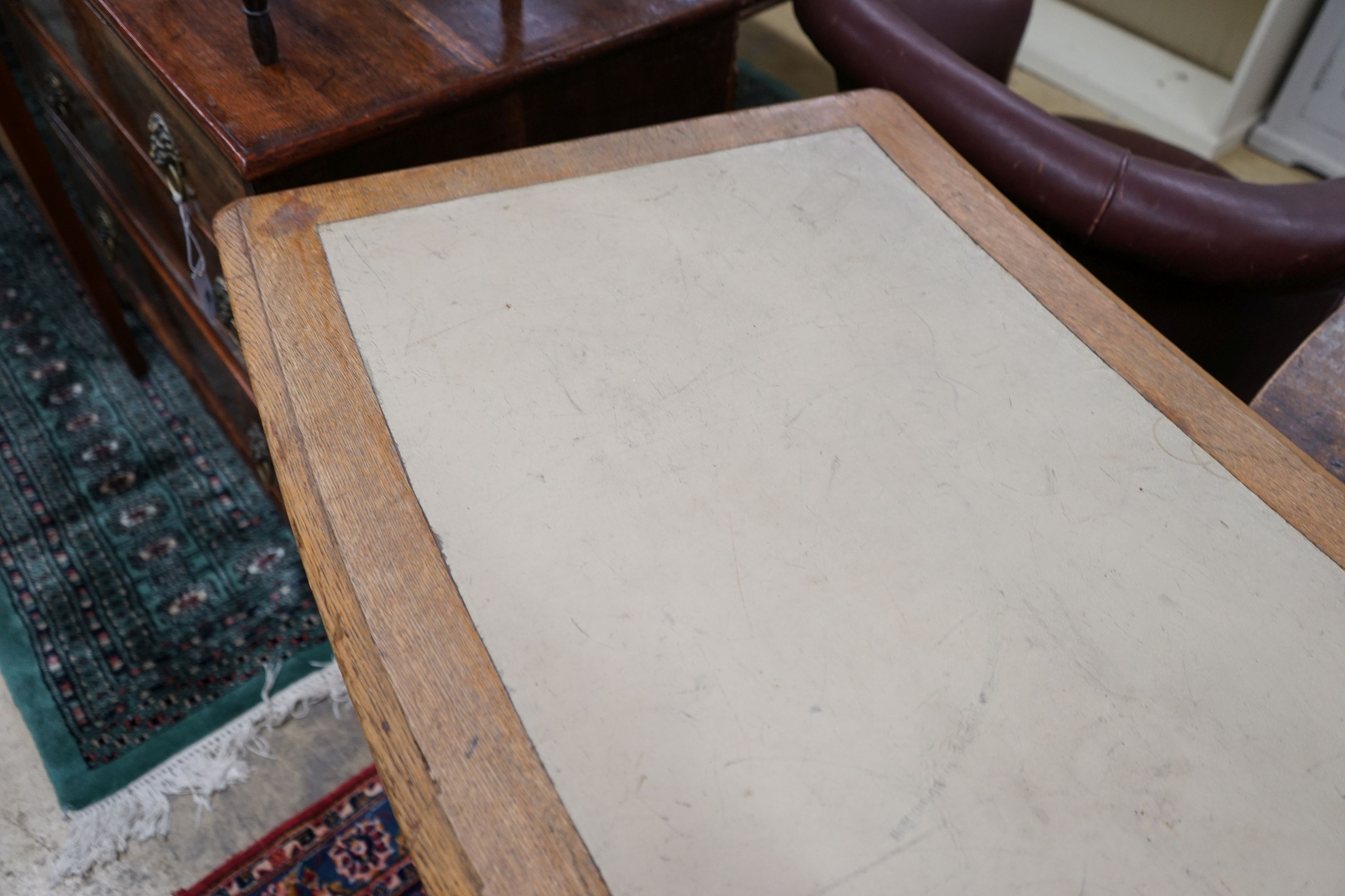 A late Victorian oak four drawer library table of curved rectangular form, length 240cm, depth 60cm, height 80cm